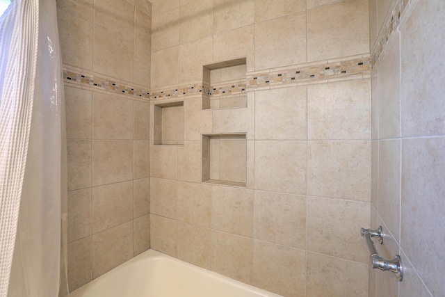 bathroom with shower / tub combo with curtain