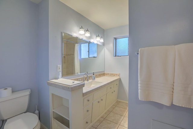 bathroom with tile patterned flooring, vanity, toilet, and curtained shower