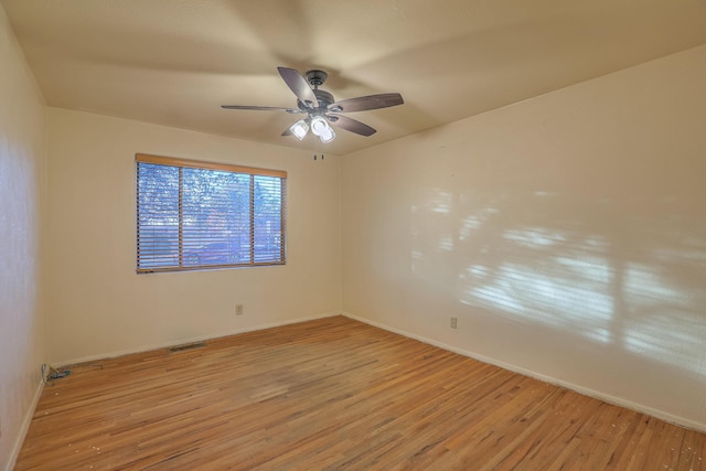 spare room featuring light hardwood / wood-style floors and ceiling fan