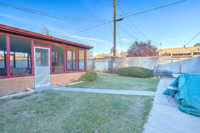 view of yard with a sunroom