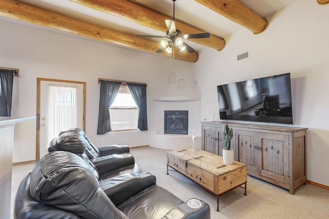 carpeted living room with ceiling fan and beam ceiling