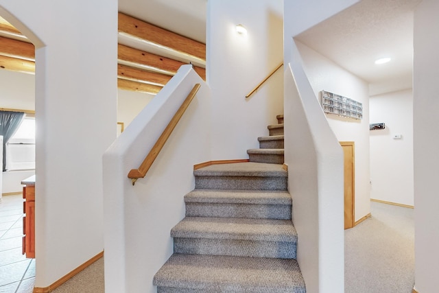 stairway featuring tile patterned flooring