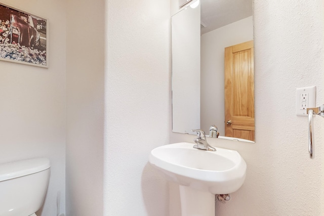 bathroom with toilet and sink