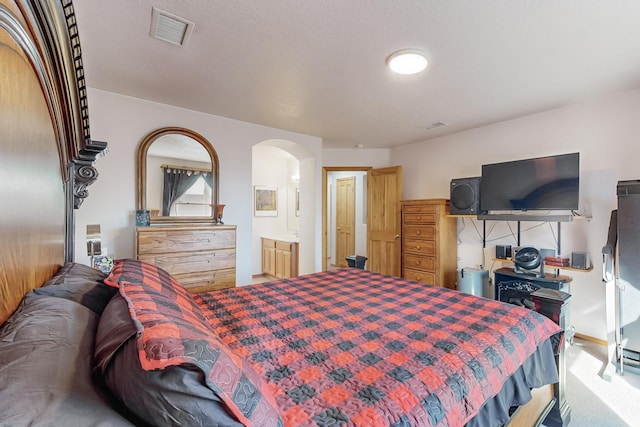 bedroom with carpet floors and ensuite bathroom