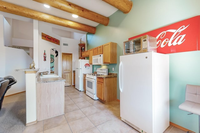 kitchen with beamed ceiling, light tile patterned floors, white appliances, and sink