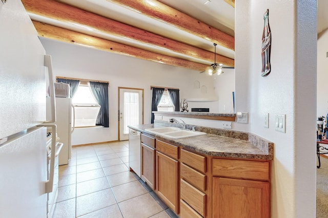 kitchen featuring beam ceiling, white appliances, a wealth of natural light, and sink