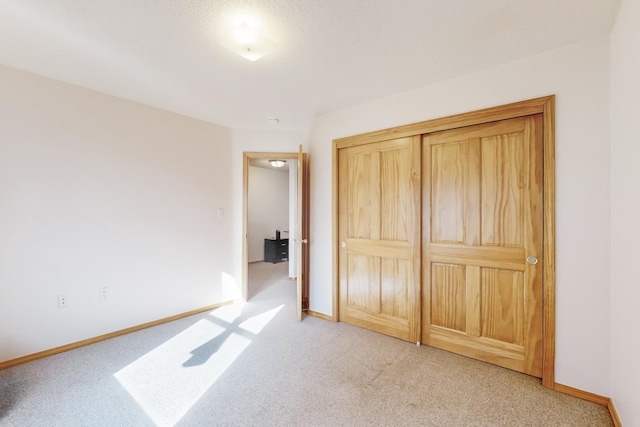 unfurnished bedroom featuring light carpet