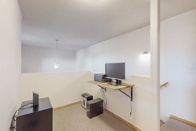 carpeted office with a textured ceiling