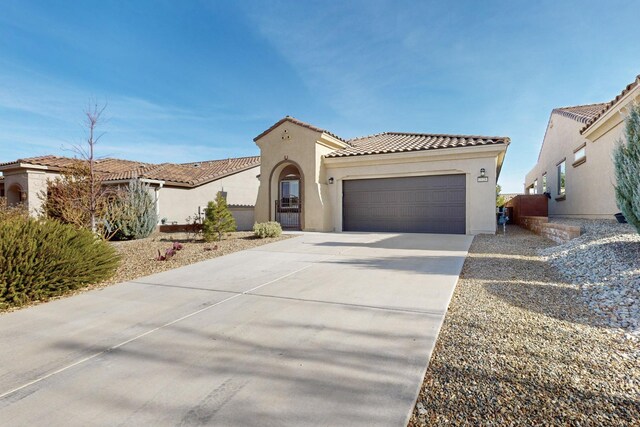 mediterranean / spanish home with a garage