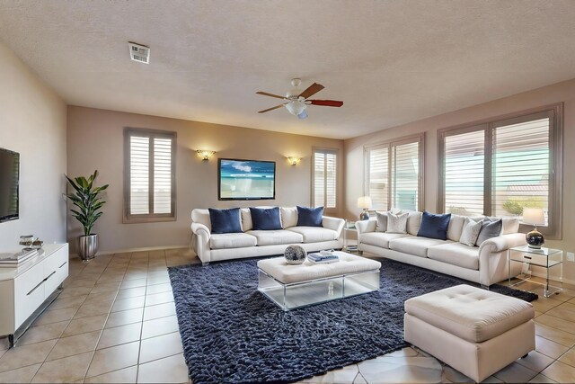 unfurnished living room with light tile patterned floors and ceiling fan