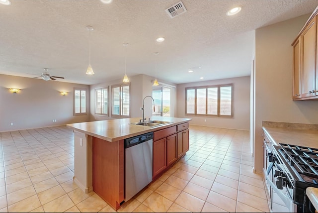 kitchen with ceiling fan, sink, decorative light fixtures, a kitchen island with sink, and appliances with stainless steel finishes