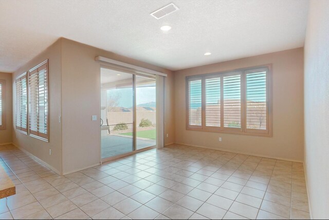 spare room featuring ceiling fan, carpet, and a textured ceiling