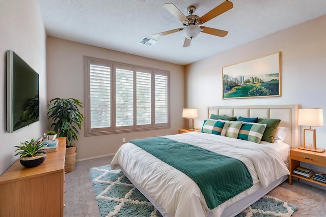 carpeted bedroom with ceiling fan, visible vents, and baseboards