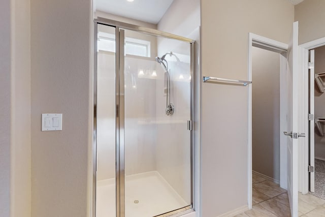 full bath with a spacious closet and a shower stall