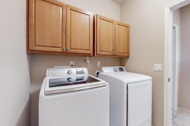 laundry area with cabinet space and washer and clothes dryer