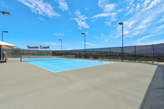 view of tennis court featuring a mountain view and basketball hoop