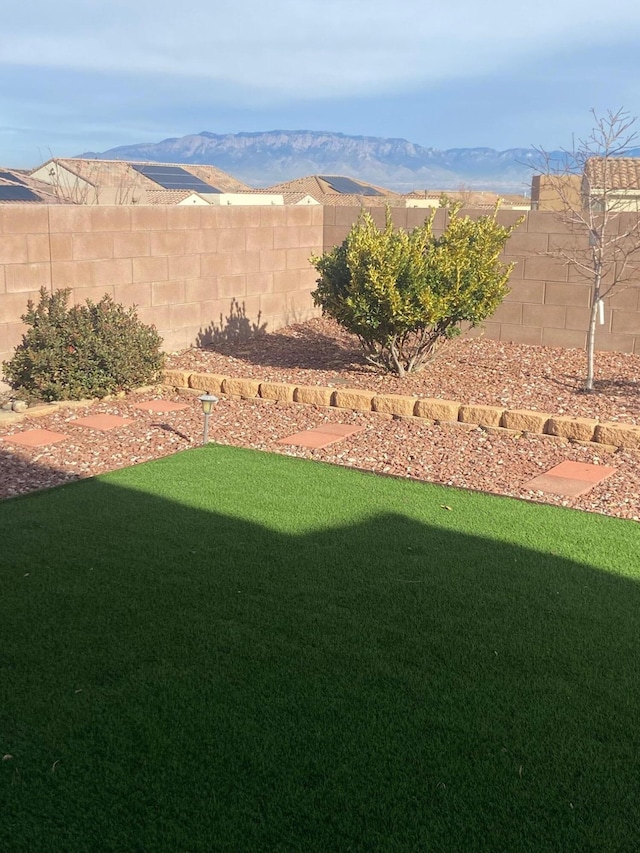 view of yard featuring a fenced backyard and a mountain view