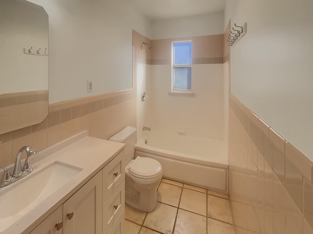 full bathroom featuring vanity, tile walls, tile patterned flooring, toilet, and tiled shower / bath