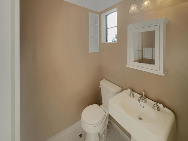 bathroom with tile patterned floors, toilet, and sink