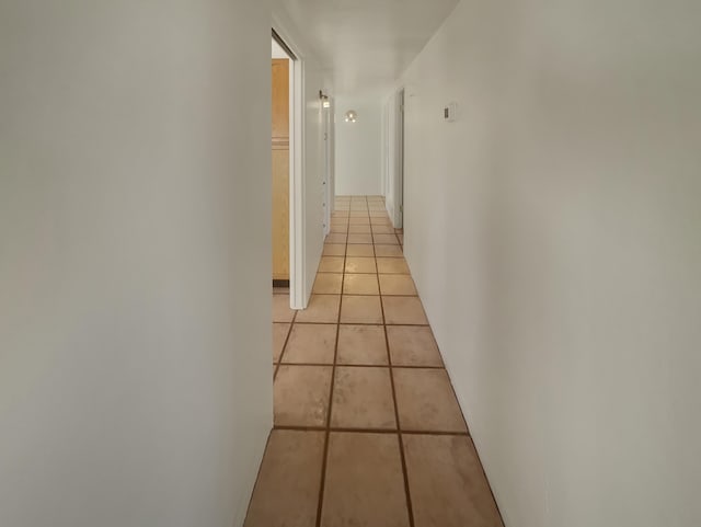 corridor featuring light tile patterned floors