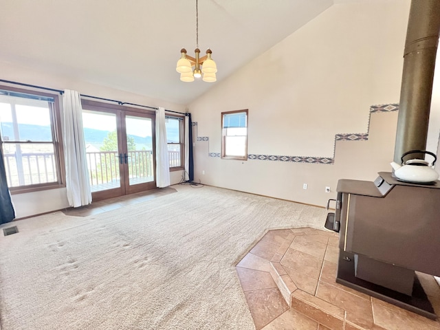 interior space with french doors, high vaulted ceiling, and a notable chandelier