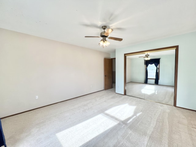 unfurnished bedroom featuring ceiling fan, light colored carpet, and a closet