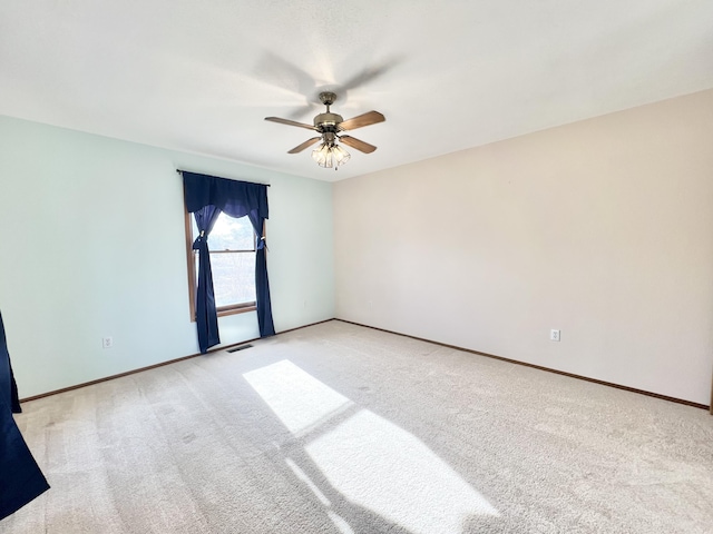 unfurnished room with ceiling fan and light colored carpet