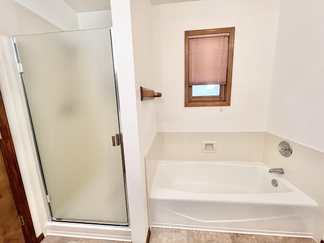 bathroom featuring shower with separate bathtub