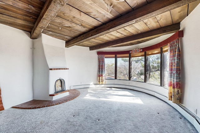 unfurnished living room featuring carpet flooring, beamed ceiling, and wood ceiling