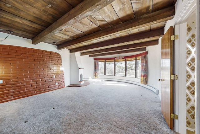 unfurnished living room with wood ceiling, beamed ceiling, brick wall, and carpet