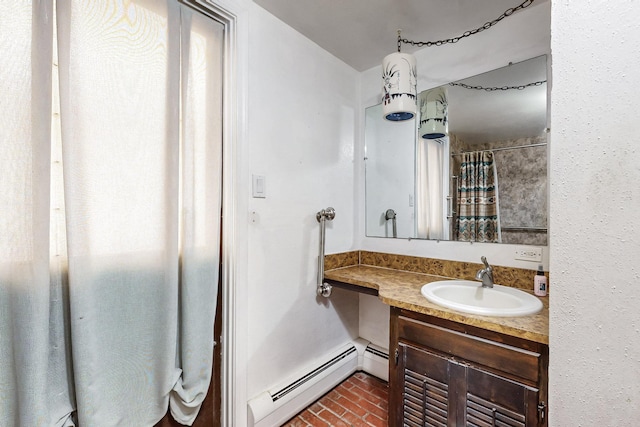 bathroom with baseboard heating and vanity