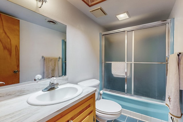 full bathroom with tile patterned floors, toilet, vanity, and combined bath / shower with glass door