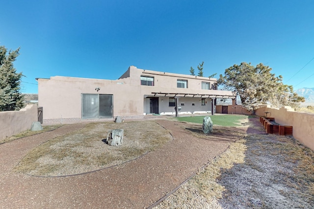 rear view of house featuring a yard