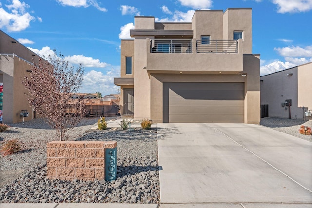 view of front of home featuring a garage and a balcony