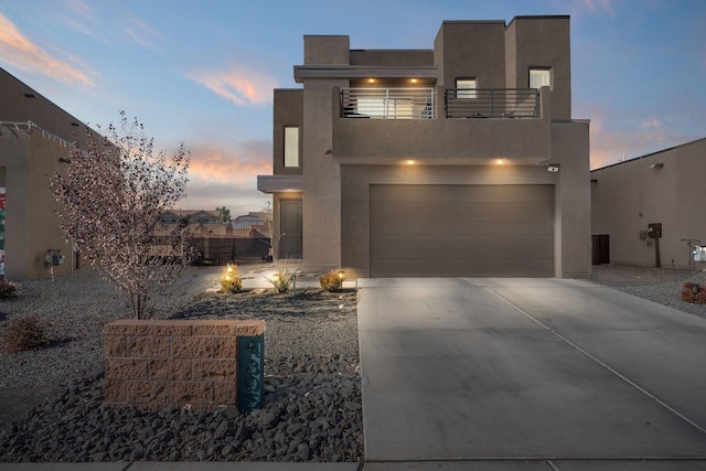 view of front of house featuring a balcony and a garage