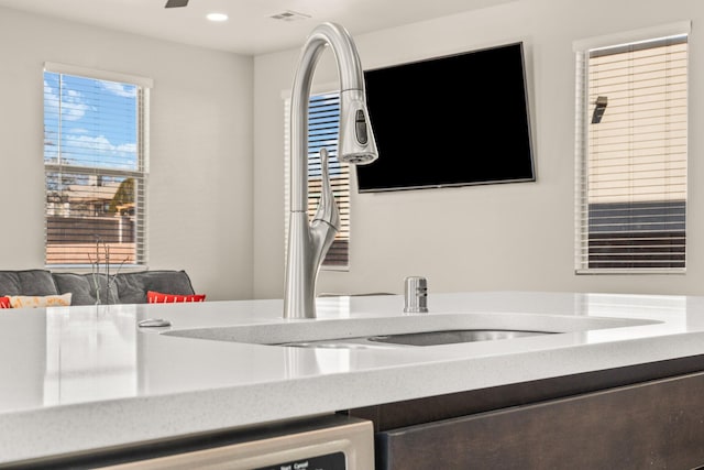 interior space with ceiling fan and dishwashing machine