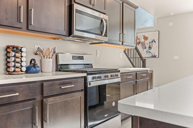 kitchen featuring appliances with stainless steel finishes and dark brown cabinets