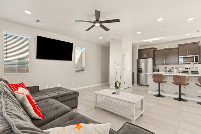 tiled living room with ceiling fan