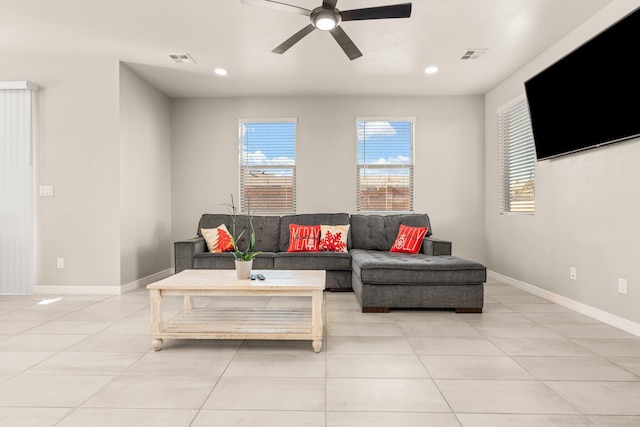 living room featuring light tile patterned floors and ceiling fan