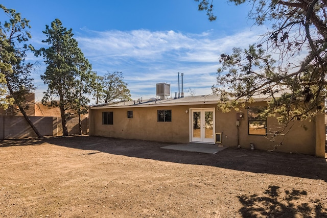 back of house featuring central AC and french doors