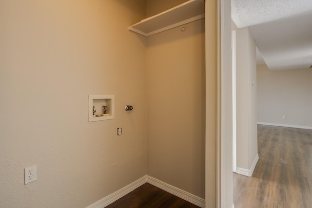 laundry room with washer hookup, a textured ceiling, and hardwood / wood-style flooring