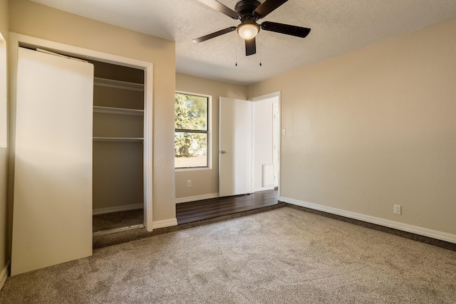 unfurnished bedroom featuring carpet flooring, ceiling fan, a textured ceiling, and a closet