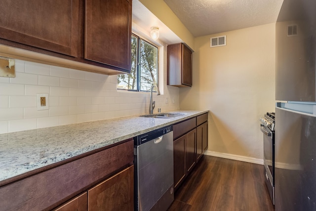 kitchen with dark hardwood / wood-style flooring, light stone counters, sink, and stainless steel appliances