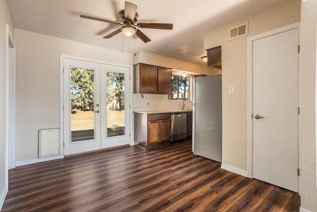 kitchen featuring french doors, stainless steel appliances, a wealth of natural light, and dark hardwood / wood-style floors