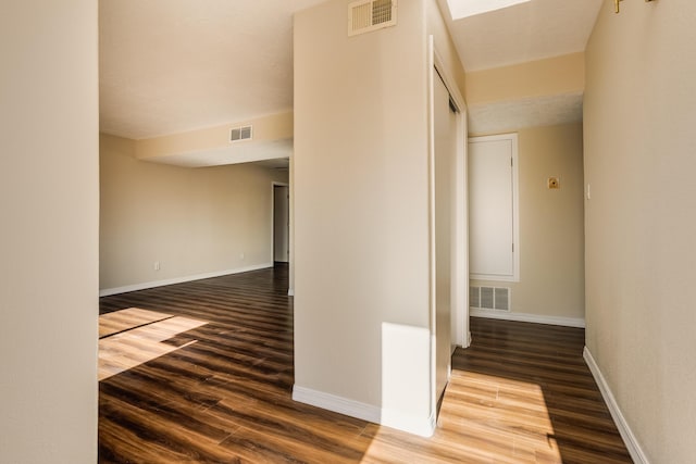 corridor with wood-type flooring