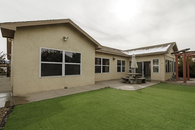 back of property featuring a yard and a patio