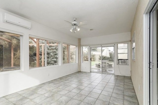 unfurnished sunroom with plenty of natural light, a wall mounted AC, and ceiling fan