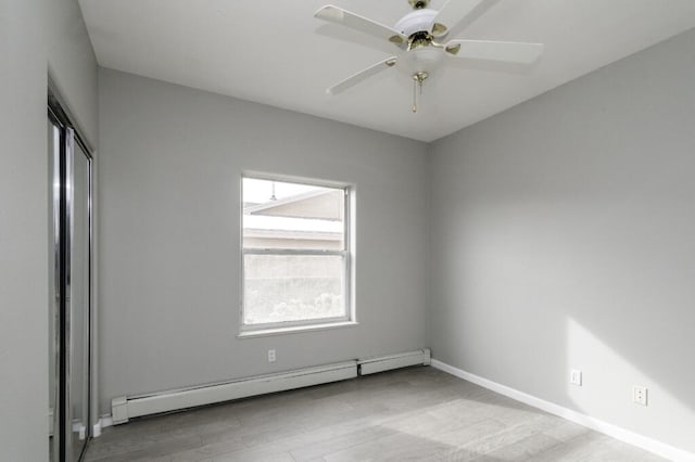 spare room with ceiling fan, light hardwood / wood-style flooring, and a baseboard radiator