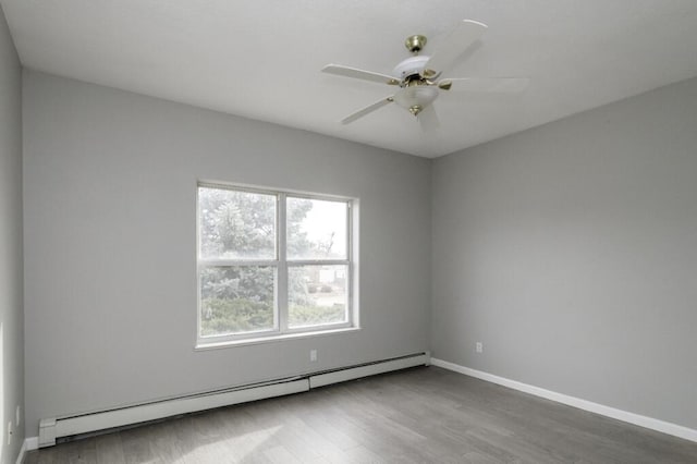 empty room with hardwood / wood-style floors, ceiling fan, and a baseboard radiator