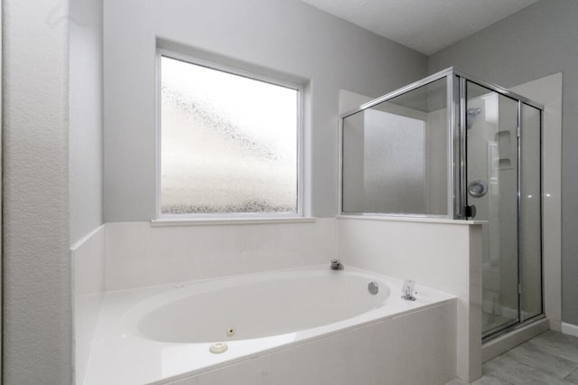 bathroom with shower with separate bathtub